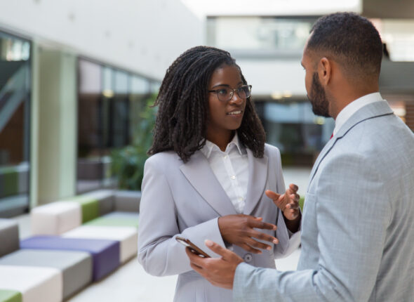 Smiling young business people talking